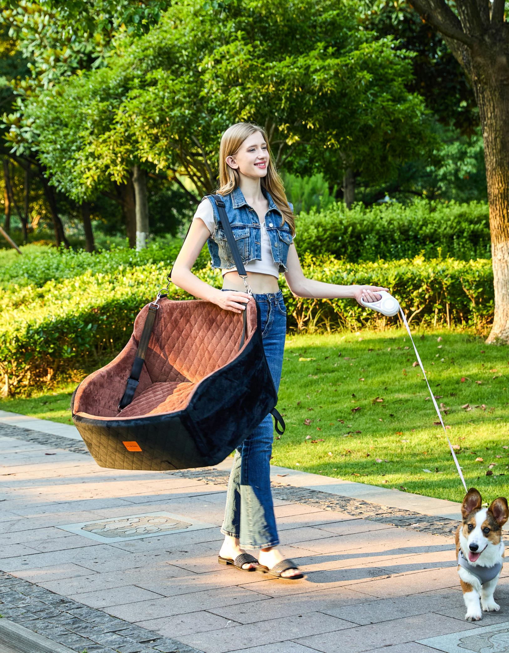 Woman carrying pet bed outdoors